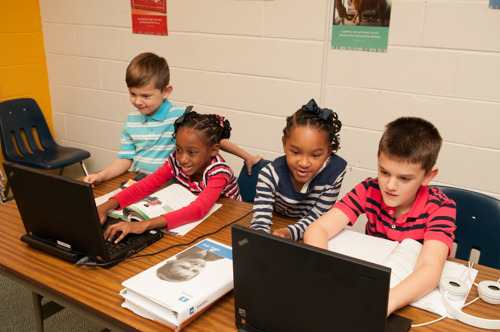 Academy students looking at their laptops.